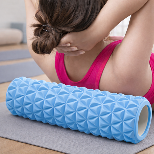 Woman using textured foam roller for deep tissue back massage and muscle recovery