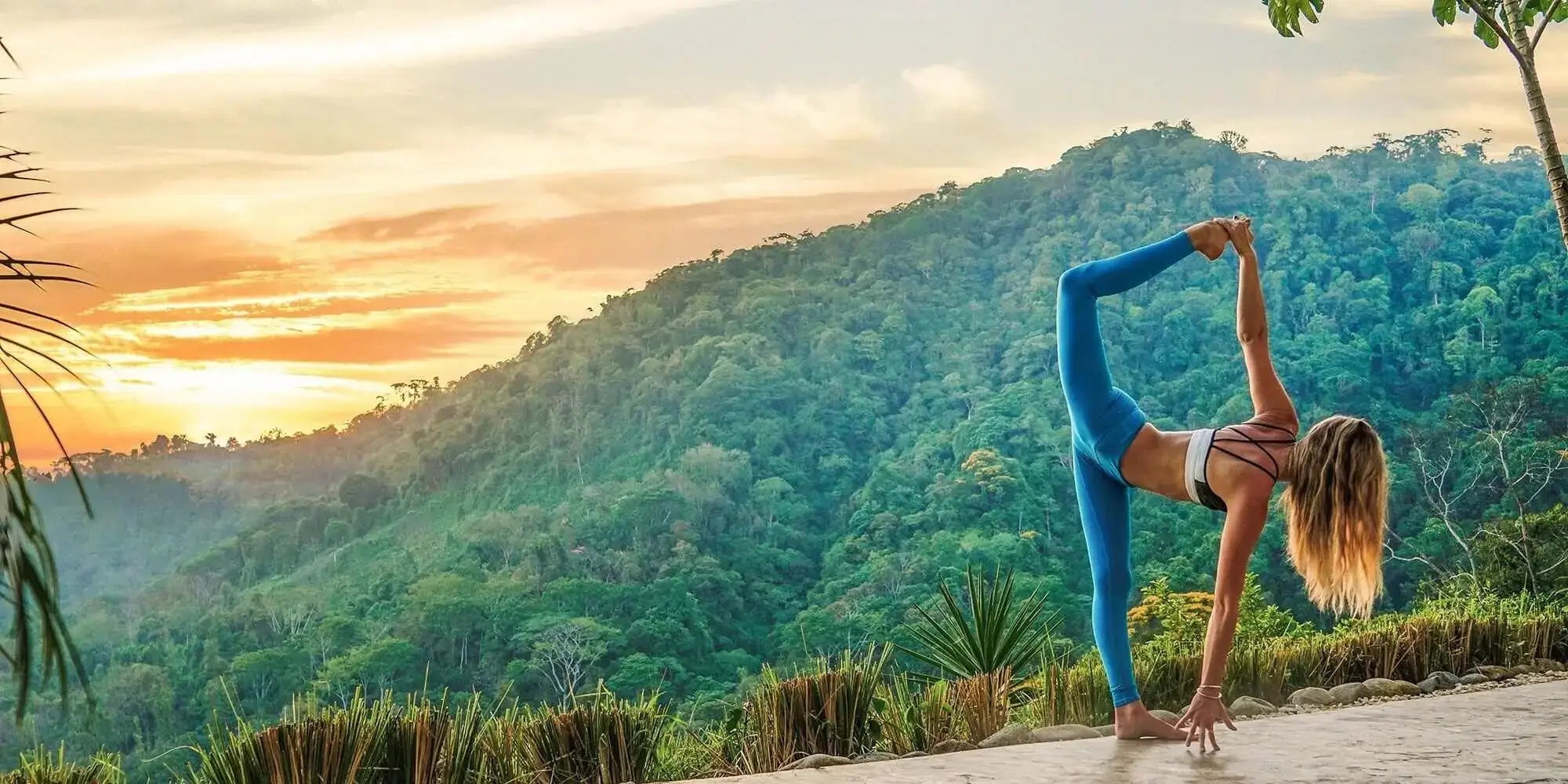woman practicing yoga at sunrise in tropical mountains – Eravi yoga lifestyle
